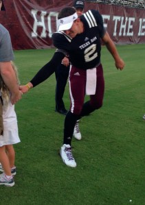 Johnny Manziel flirting with our youngest when she was too shy to shake his hand. Either that or he was taunting her for not being able to stop him. He did point to the scoreboard after this...